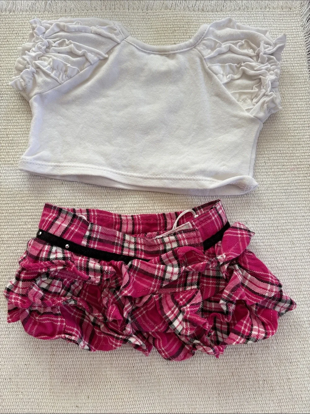 Build-A-Bear outfit featuring a graphic dog tee and a pink plaid ruffled skirt.